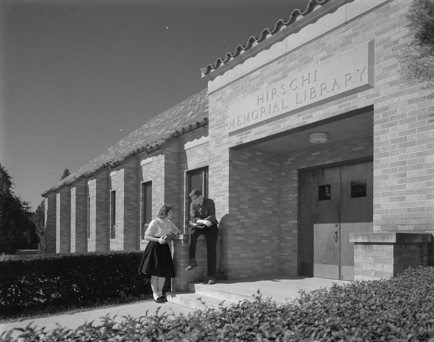 Students on the steps of a library located on 3400 East Avenue at Concordia Lutheran College, 1961