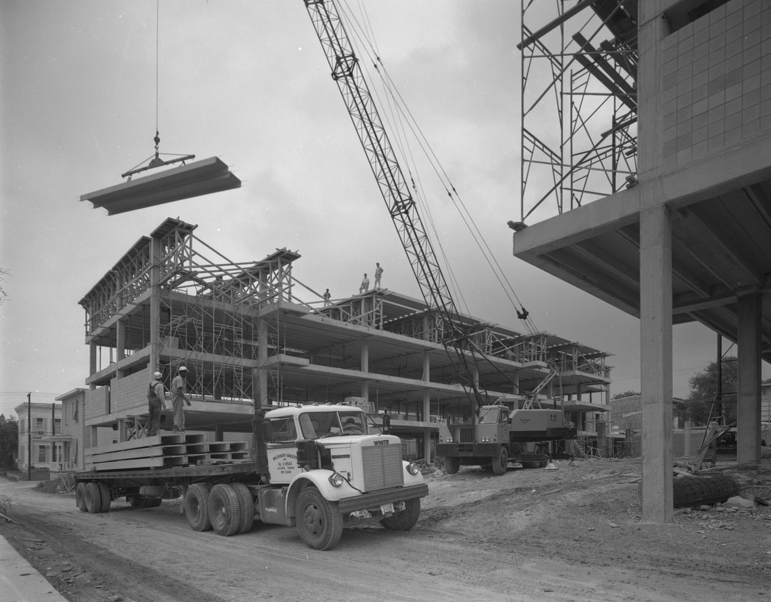 A steel beam framed building under construction, 1965