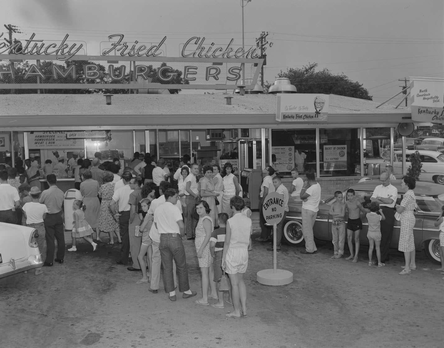 Customers standing in front of Kentucky Fried Chicken stand, Austin, 1960