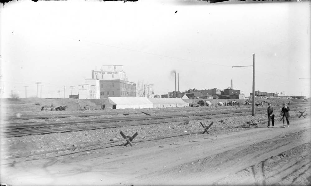 View of construction of the Denver Tramway's storage yard and tracks near Jason Avenue (Santa Fe Drive) and Bayaud Street in Denver, 1904.