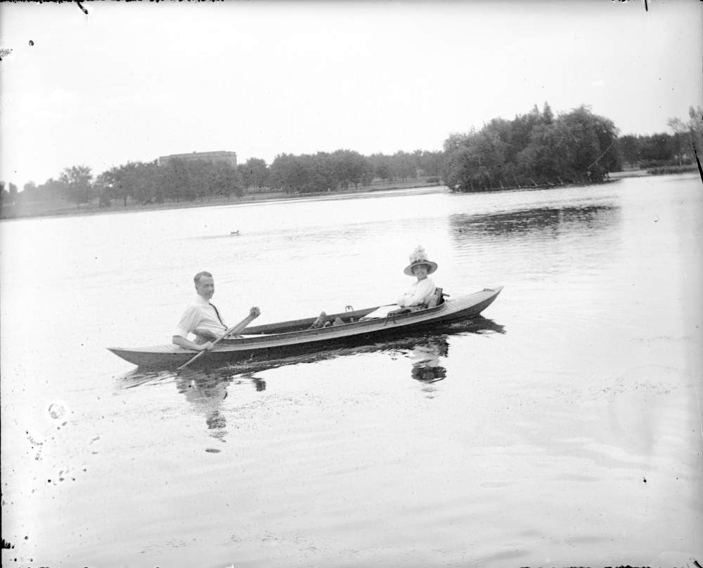 A man and woman pose in a canoe on City Park (Ferril) Lake in City Park, Denver, 1910