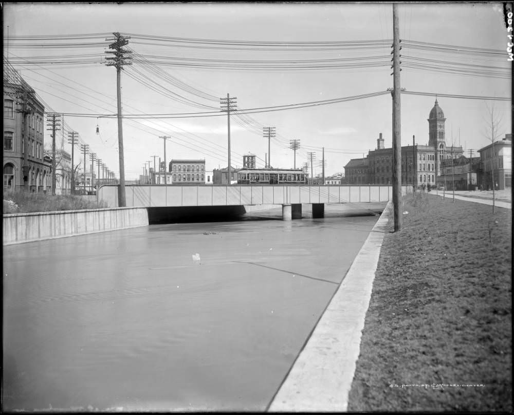 Cherry Creek and (possibly) Lawrence Street bridge, in Denver, Colorado; shows a Denver Tramway Company street railway car, 1907