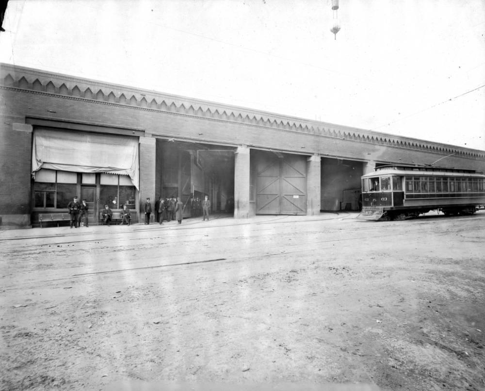 Conductors and trolley number 63 in front of the Denver Tramway Company garage on 30th (Thirtieth) Avenue in Denver, 1905