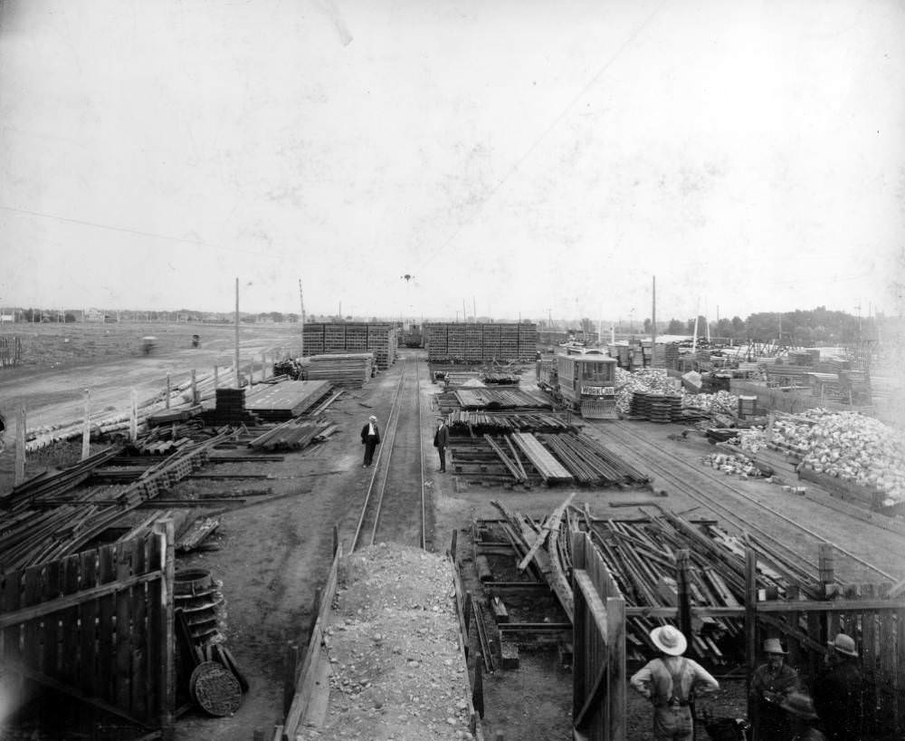 Denver Tramway Company supply yard shows: stacks of lumber and steel tracks, 1909