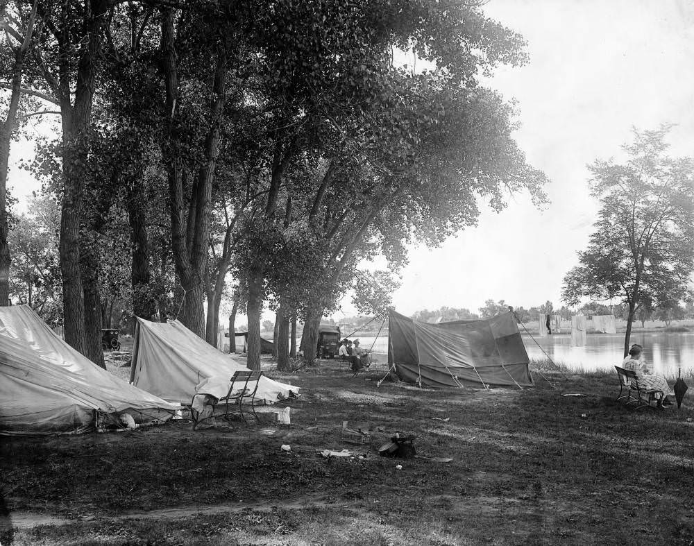 View of camp sites beside Rocky Mountain Lake at Rocky Mountain Lake Park in the Berkeley neighborhood of Denver, 1909