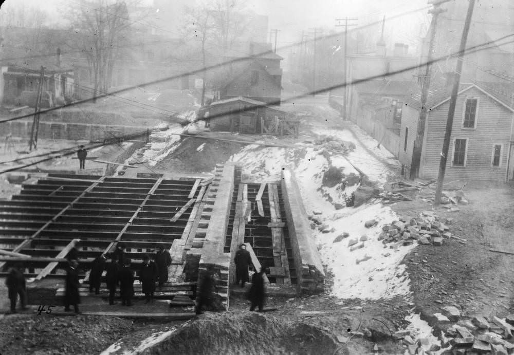 Men (including Mayor Robert Speer) inspect Denver Public Library (Carnegie) basement and foundation walls in Denver, 1907