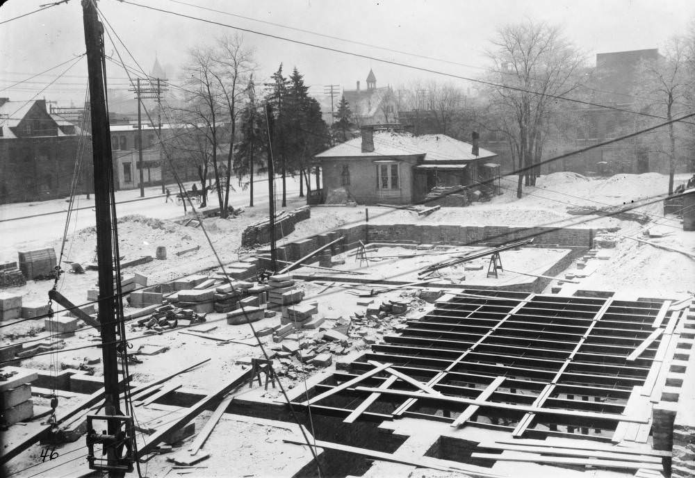 Denver Public Library (Carnegie) construction consists of snow-covered basement and foundation walls and a crane in Denver, 1907