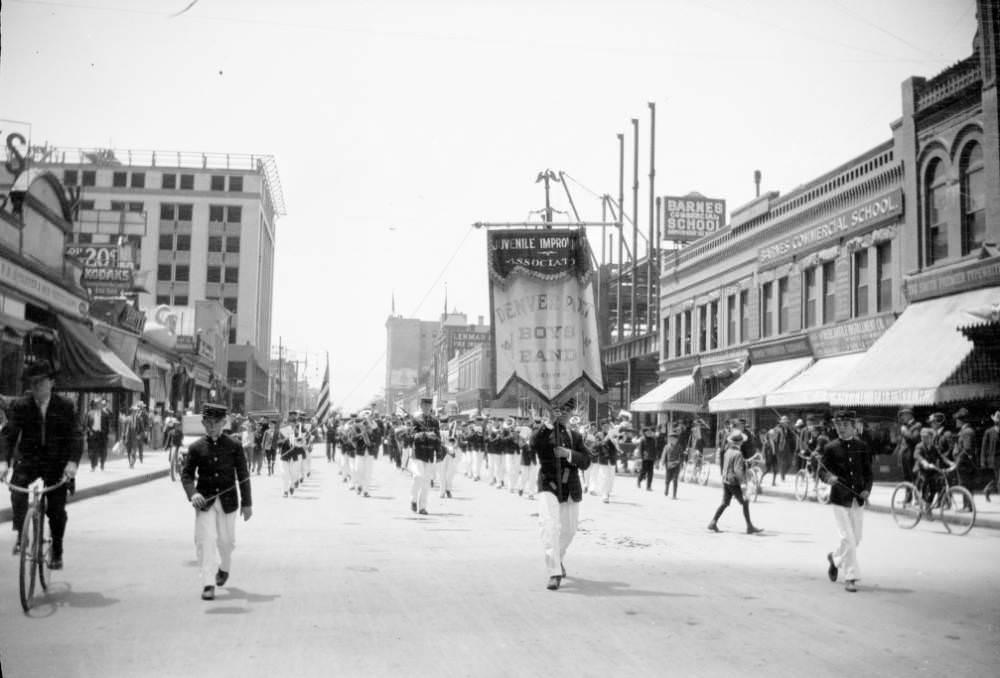 Boys in a marching band participate in a parade on Champa Street in downtown Denver, 1909