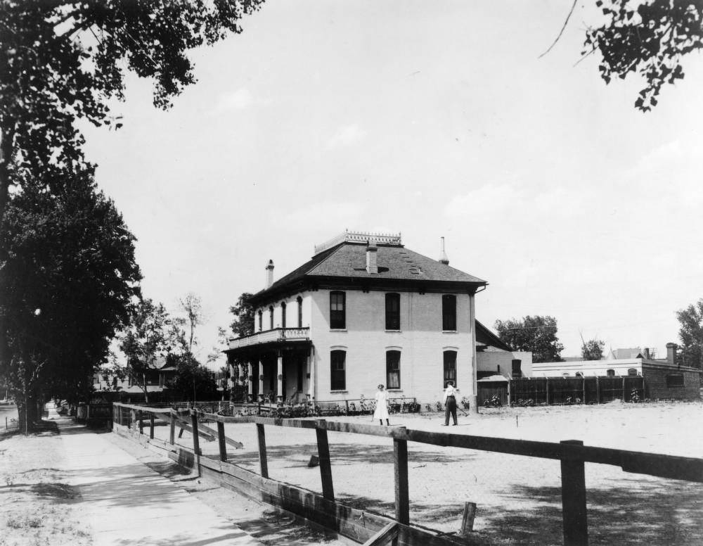 Jolin Wright and Nora B. Wright play croquet in the fenced playground of the Detention Home School (later the Gilliam Youth Center for Juvenile Justice) at 2844 Downing Street in the Five Points neighborhood of Denver, 1903