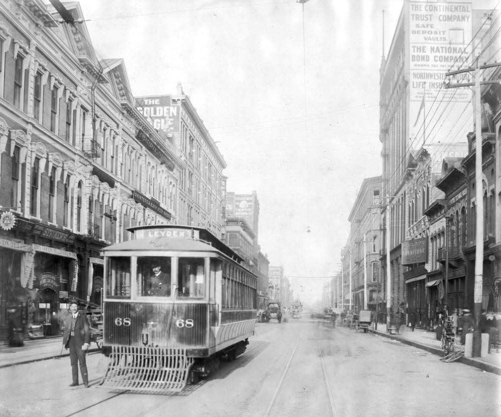 Conductors pose with Denver Tramway Company trolley, Leyden number 68, on Lawrence Street in Denver, 1905