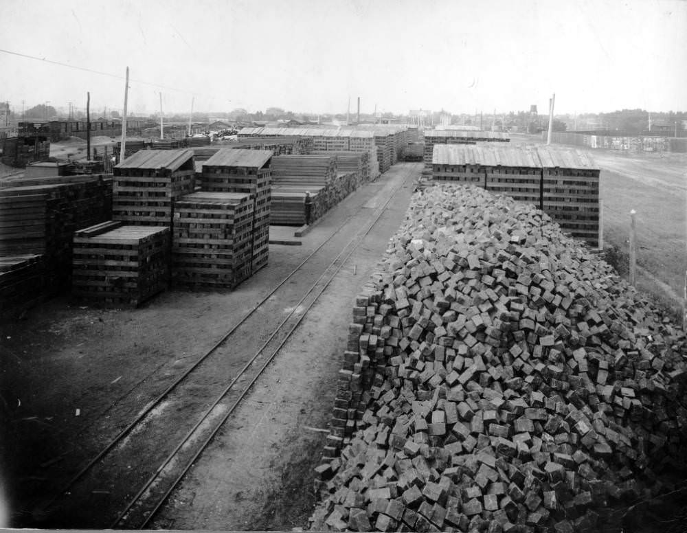 Denver Tramway Company supply yard in Denver, Colorado with stacks of lumber and piles of stone cobbles, 1909