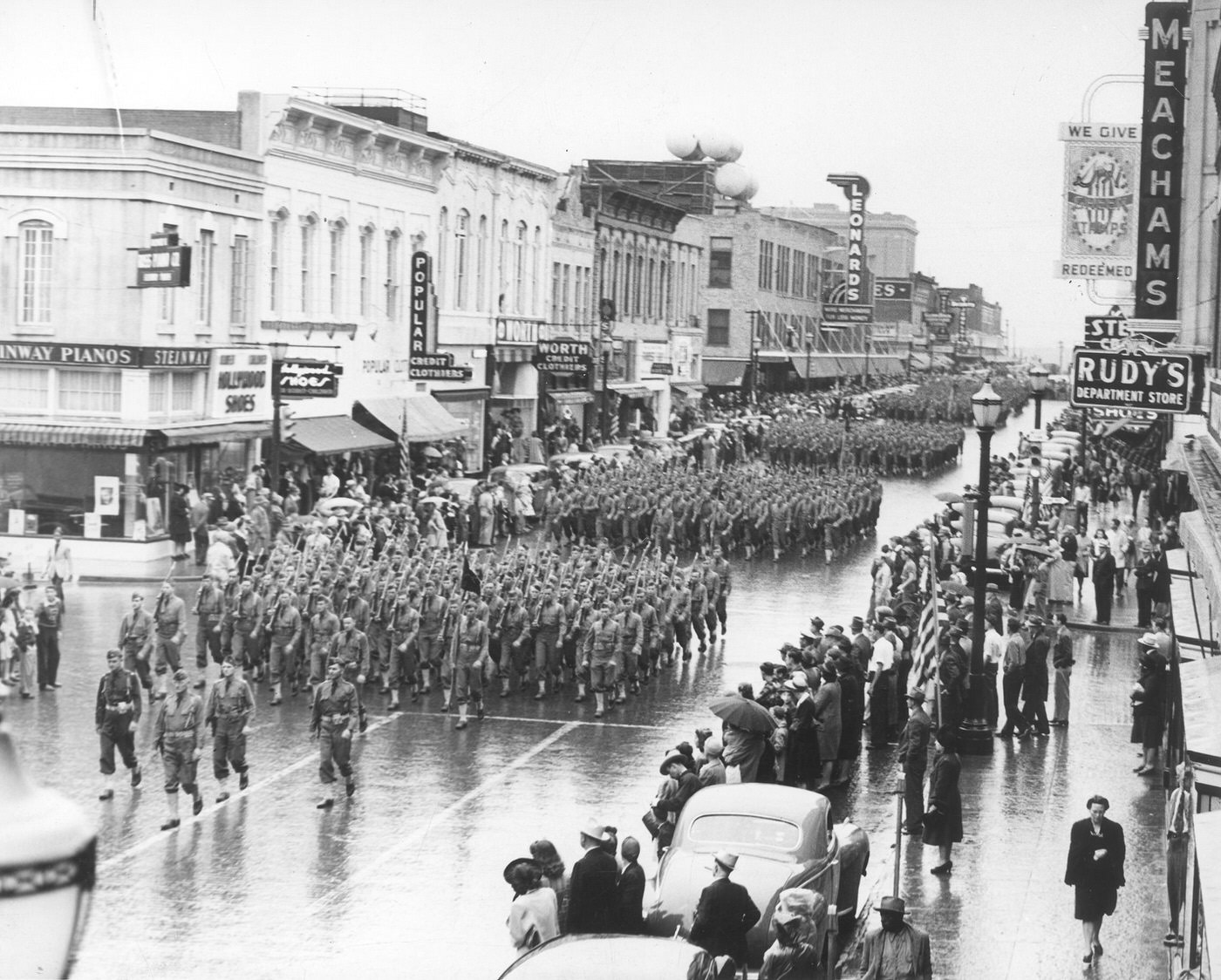 Military parade in downtown Fort Worth along Houston St. with Leonard's and Meacham department stores along the street, 1948