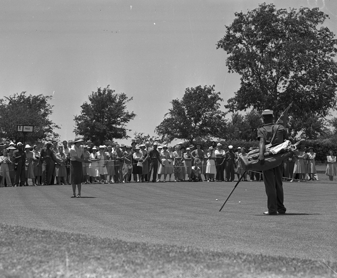 Mrs. Frank Goldthwaite making a long putt, River Crest Country Club, 1940