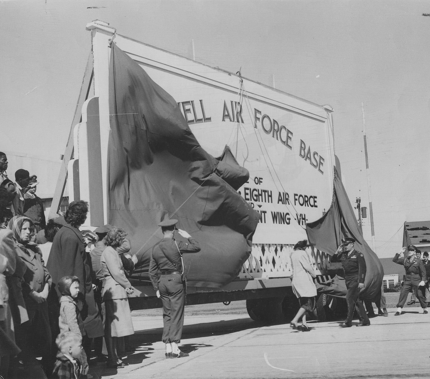 Maj. Gen. Roger M. Ramey saluting Mrs. Virginia Ede Carswell at the rededication ceremony in honor of Maj. Horace S. Carswell Jr., Carswell Air Force Base, 1948