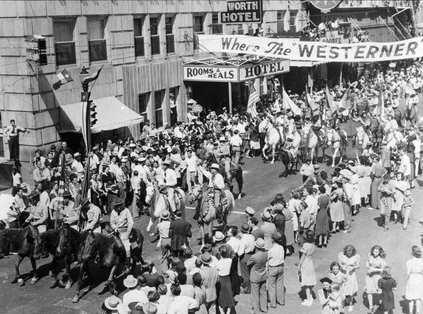 Parade through downtown Fort Worth in front of the Worth Hotel to celebrate the movie premier of "The Westerner"1940