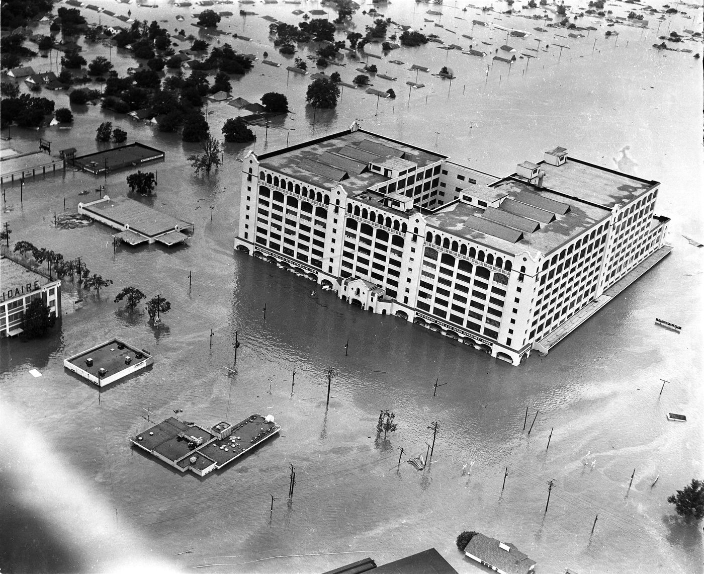 Aerial of 1949 flood in Fort Worth; Montgomery Ward store along West 7th Street, looking northwest, 1949