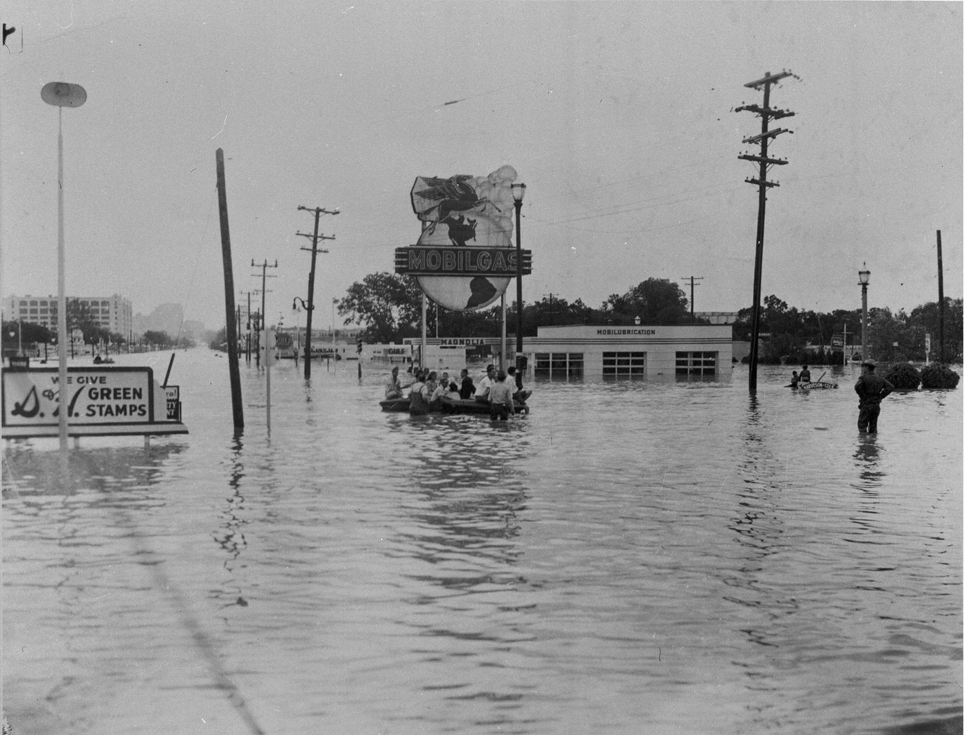 Flooded street, Green Stamps sign and Mobil Gas station, 7th St., University Dr., Camp Bowie intersection, Fort Worth, 1949