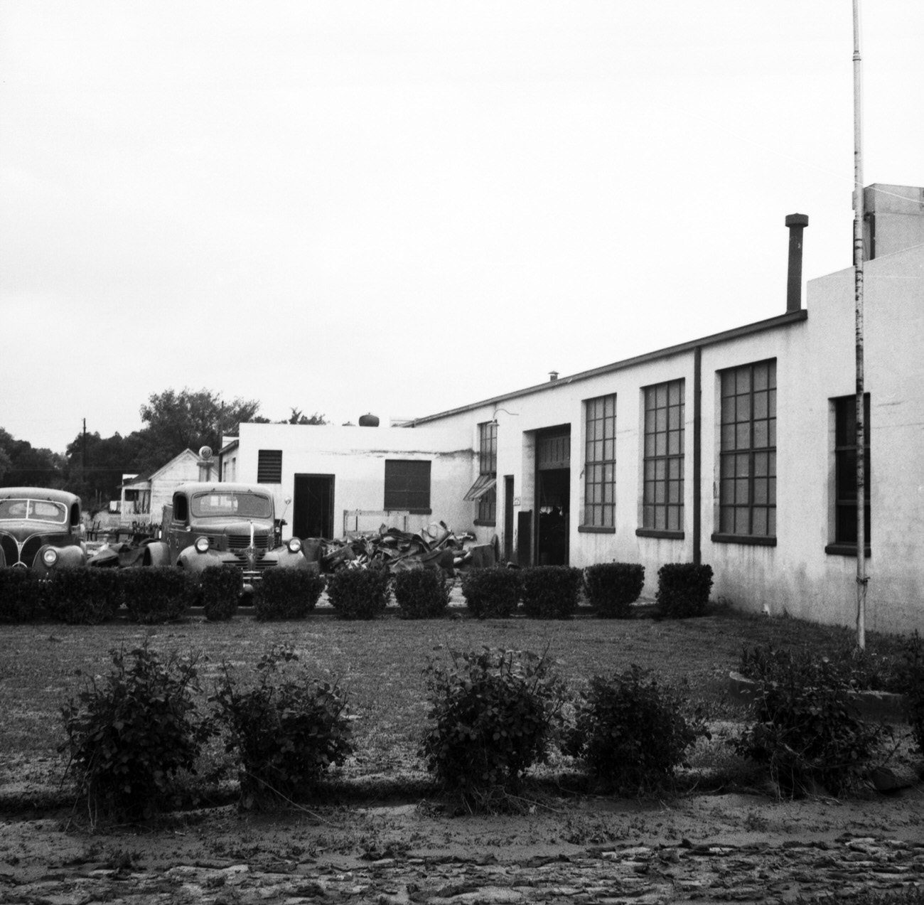 Side view of the Plastelite Engineering Company building after flood, 1949