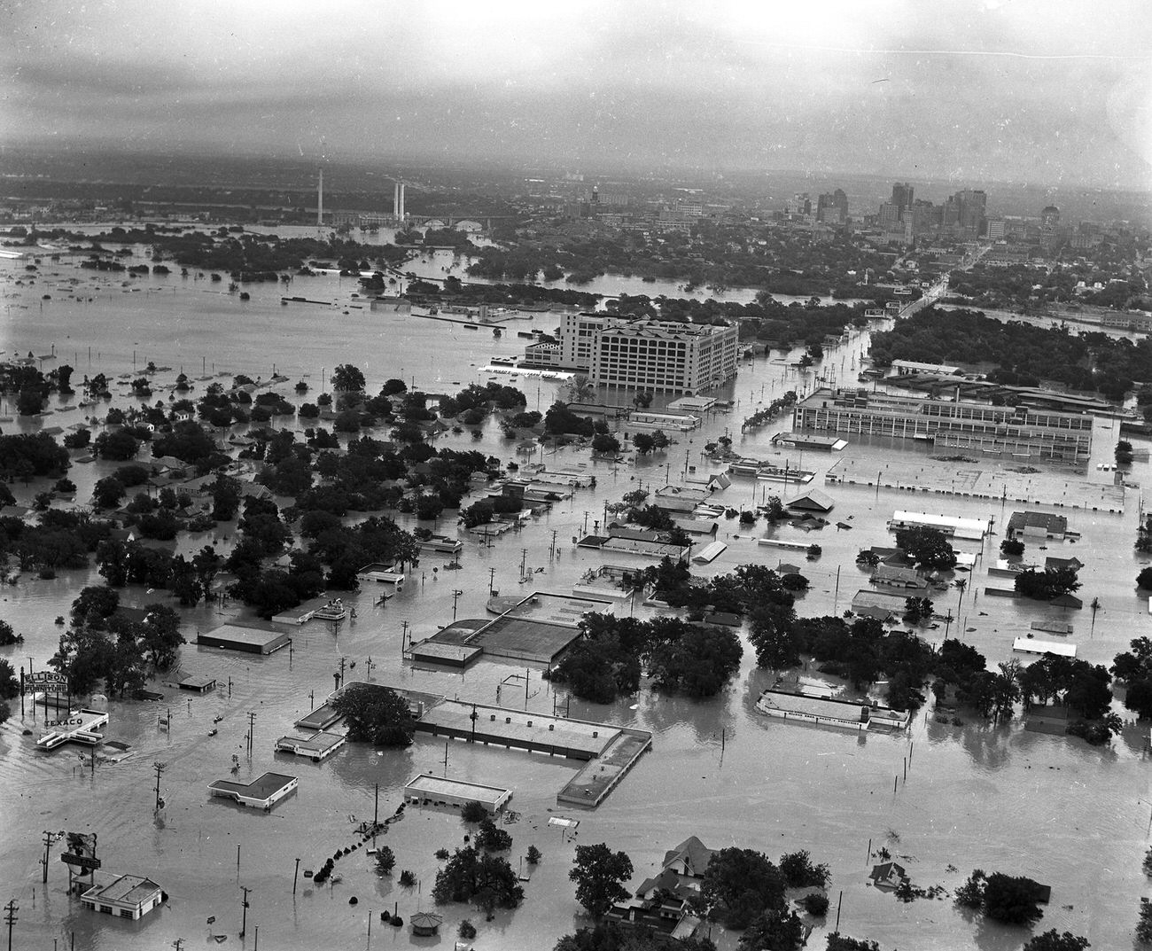 Aerial of 1949 flood in Fort Worth; looking east-northeast along West 7th Street toward Montgomery Ward, Trinity River, and downtown.