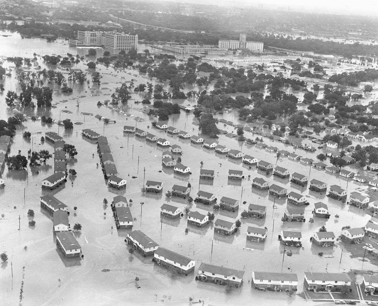 Fort Worth, Texas, flood of 1949, showing flooded homes and apartment buildings. The large Montgomery Ward building pictured in the upper left received extensive damage