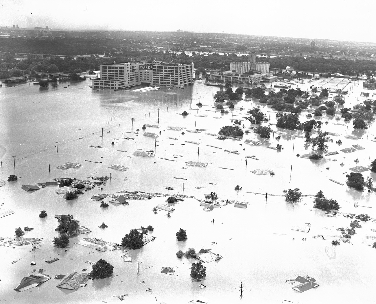 Fort Worth, Texas, flood of 1949, showing 7th Street under water. The large Montgomery Ward building received extensive damage. Downtown Fort Worth is visible in the distance.