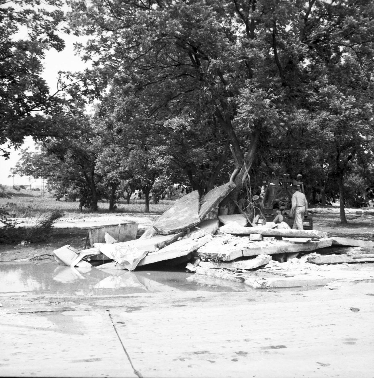 Men clearing concrete debris and wreckage after flood, 1949