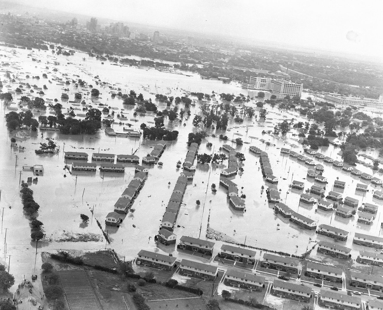 Fort Worth, Texas, flood of 1949, showing a neighborhood of homes under water. The large Montgomery Ward building received extensive damage.