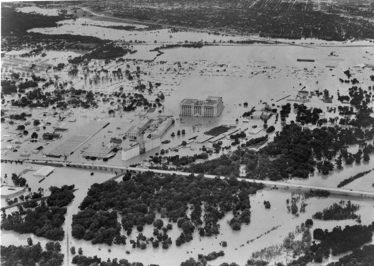 Aerial view of 1949 flood in Fort Worth showing Trinity River overflowing its banks, 7th St., and Montgomery Ward building
