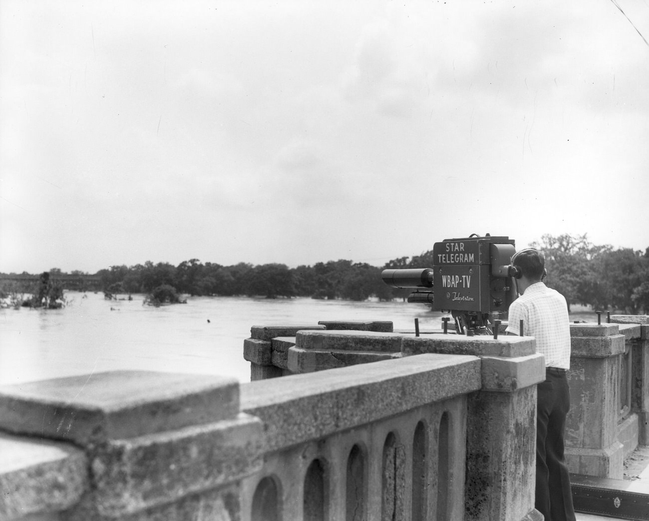 WBAP cameraman filming Trinity River flood waters from the 7th Street bridge during 1949's flood.