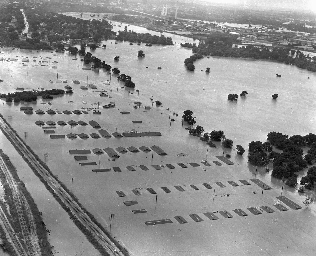 Fort Worth, Texas, flood of 1949, showing a submerged neighborhood of homes. Downtown Fort Worth is visible in the distance.