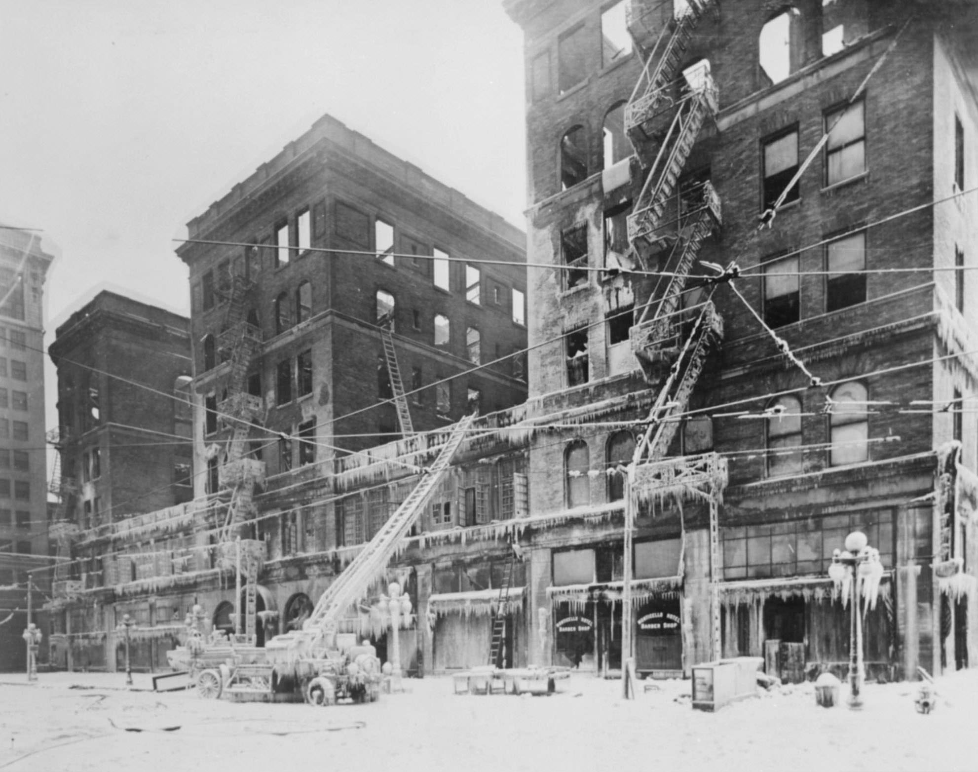 View of the burned-out Monticello Hotel, Norfolk, Virginia, and fire apparatus frosted with icicles.