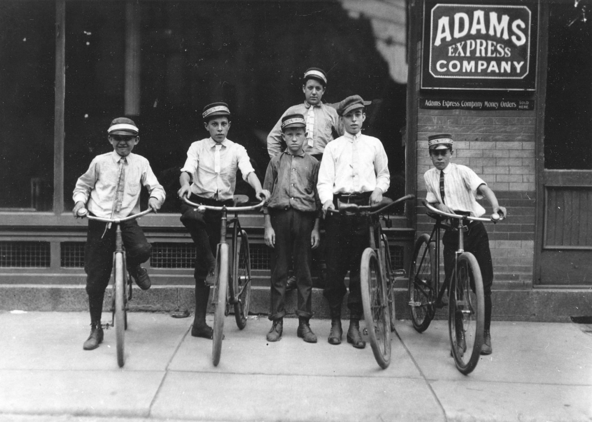 Postal messenger boys wait for deliveries on their bicycles, Norfolk, Virginia, June 1911.