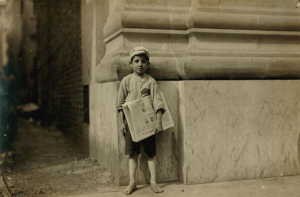 Dominick, a young Norfolk newsboy. There are too many youngsters selling papers in Norfolk, Virginia, 1911