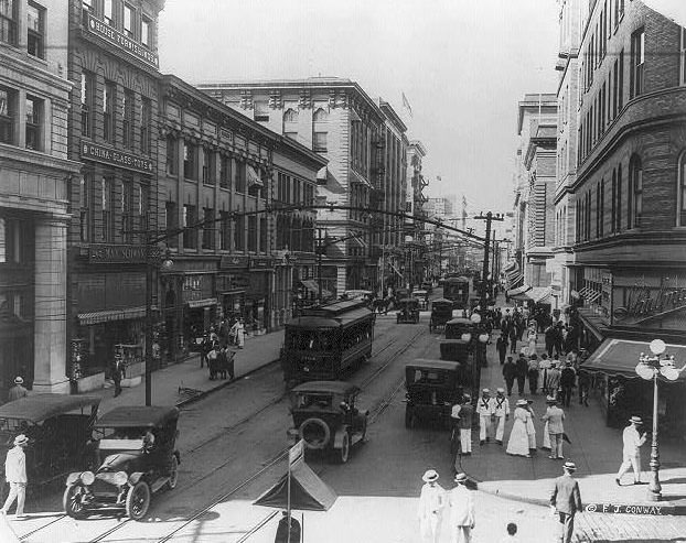 Granby Street from corner of City Hall Avenue; busy street scene with autos and electric trolleys, 1915.