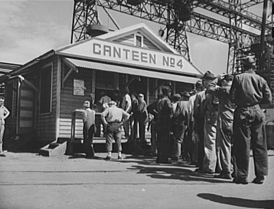 Shipbuilding (Norfolk Navy Yard). Sandwiches, smokes and soft drinks are available to workers at a number of canteens on the grounds. There are also several cafeterias serving hot meals, 1941