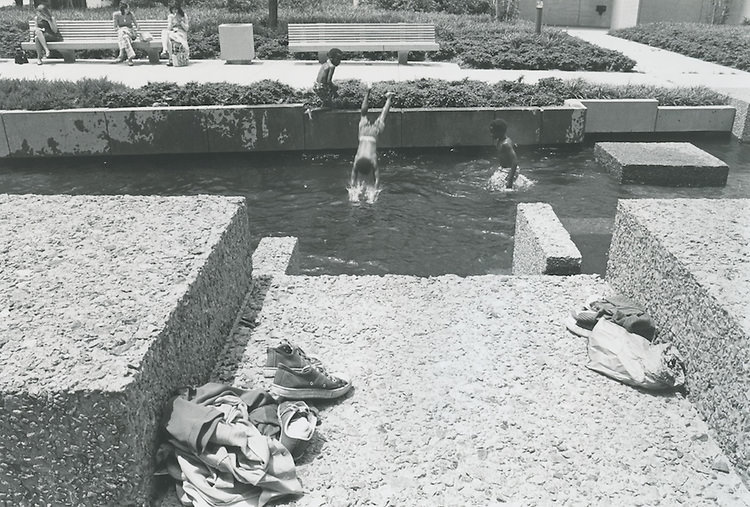 Kids swimming in fountain. 1960s