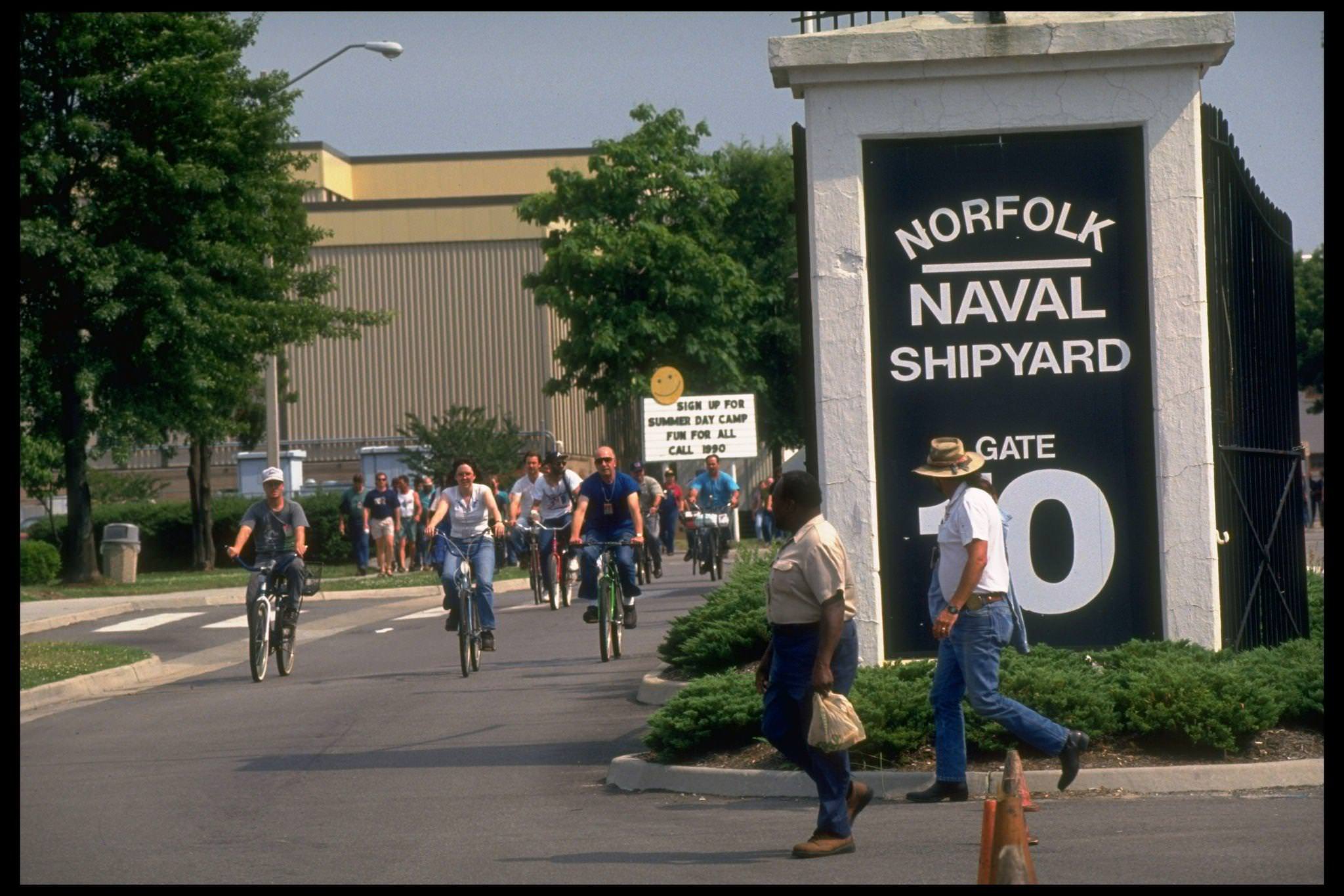 Bicyling employees leaving Norfolk Naval, Norfolk, 1990s