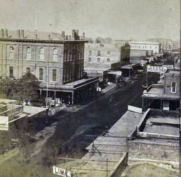 Raised view of the Free Mason's Hall on K street in Sacramento (southwest corner of k and 6th streets). Street is lined with storefronts and restaurants, including Louisiana Restaurant (164 K street).