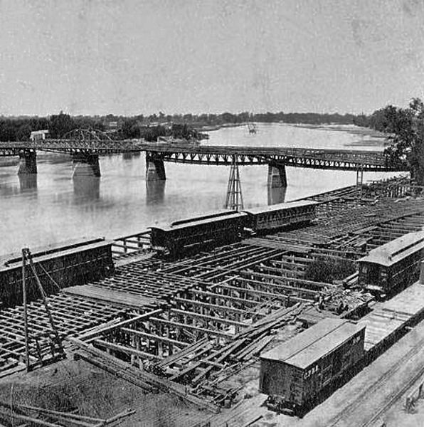 Bridge across the Sacramento and C.P.R.R. Cars, 1870.