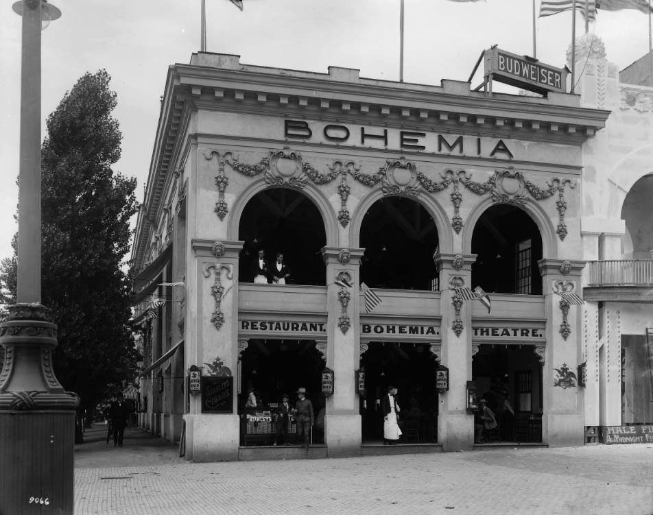 Waiters on the open-air second floor of the Bohemia Restaurant look down at the Pike at the Louisiana Purchase Exposition, 1904