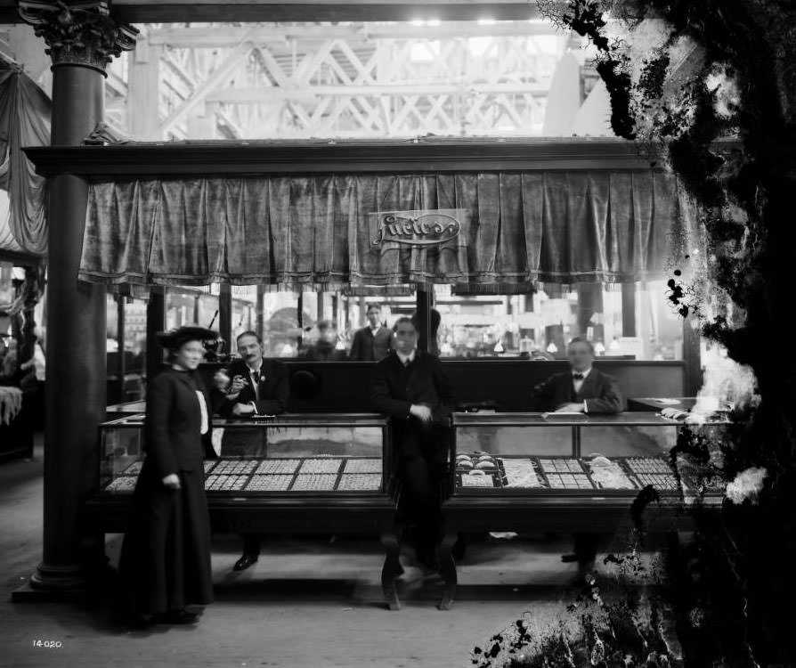 Staff from Lucio's show jewelry to potential customers in the Palace of Manufactures at the Louisiana Purchase Exposition, 1904