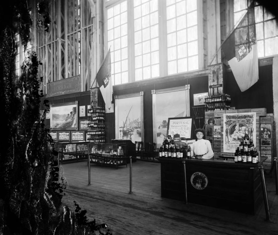 A woman served port, white and red wines to exhibit visitors at Portugal's wine exhibit in the Palace of Agriculture at the Louisiana Purchase Exposition, 1904