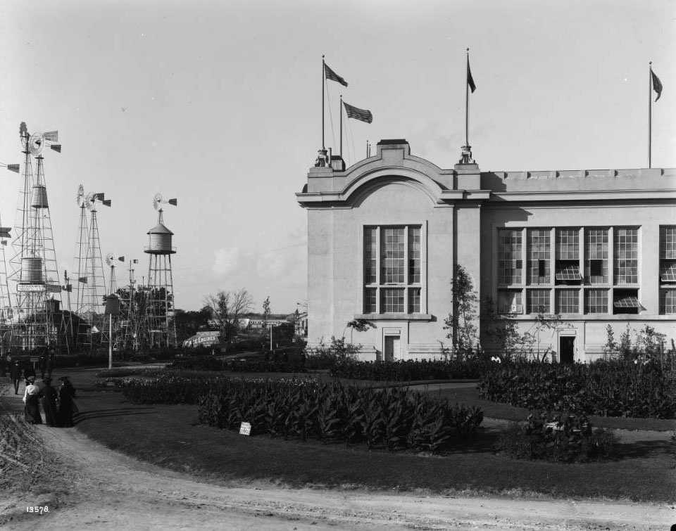 Fairgoers stroll around the outside exhibits by the Agriculture building at the Louisiana Purchase Exposition, 1904