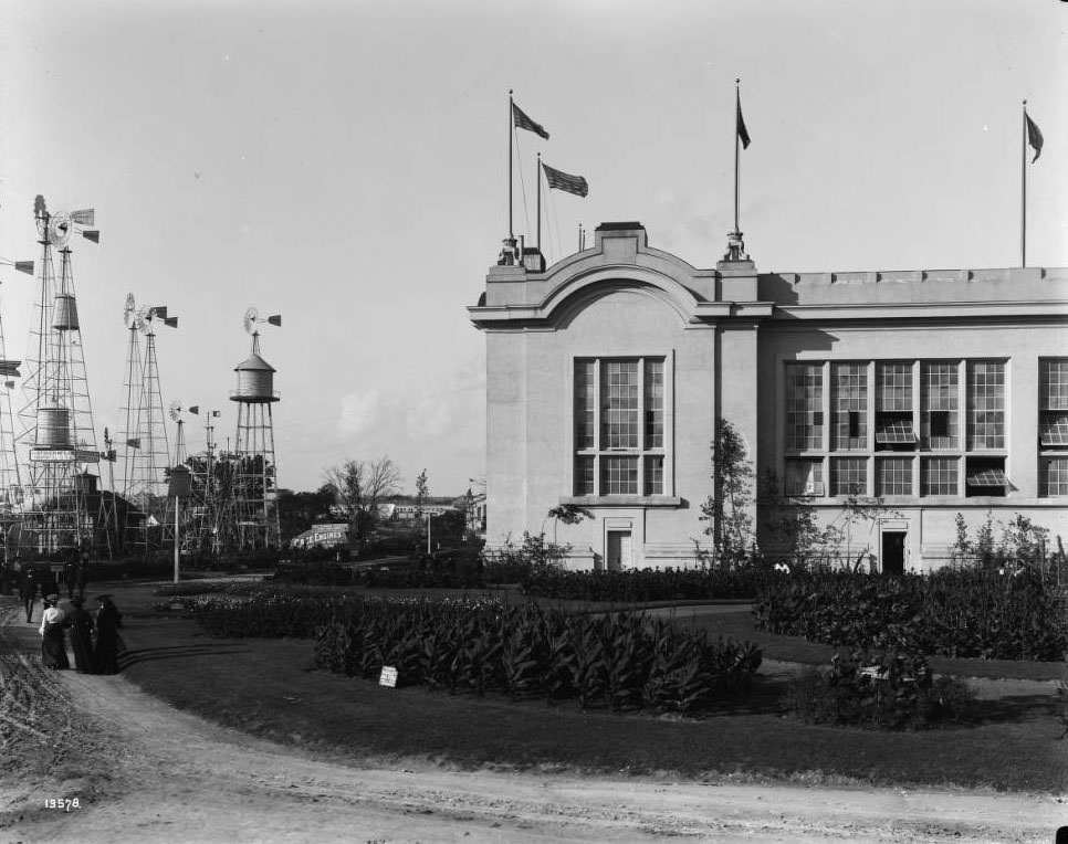 Fairgoers stroll around the outside exhibits by the Agriculture building at the Louisiana Purchase Exposition, 1904