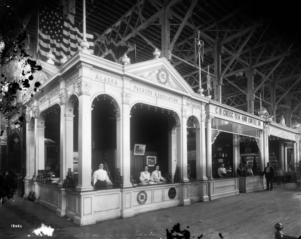 Young women offered samples of Alaska salmon in the Alaska Packers Association booth in the Agriculture building at the Louisiana Purchase Exposition, 1904