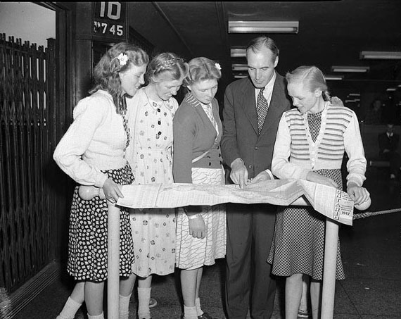Dutch immigrants at Union Station puzzle over a 1947 Ontario road map.