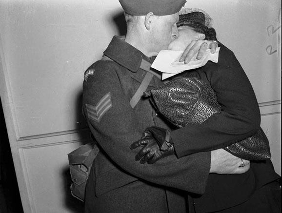 Soldier locked in a passionate embrace on return to Toronto, 1940s