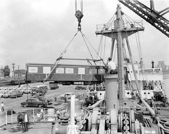 Subway cars being offloaded from a shipment, 1950s