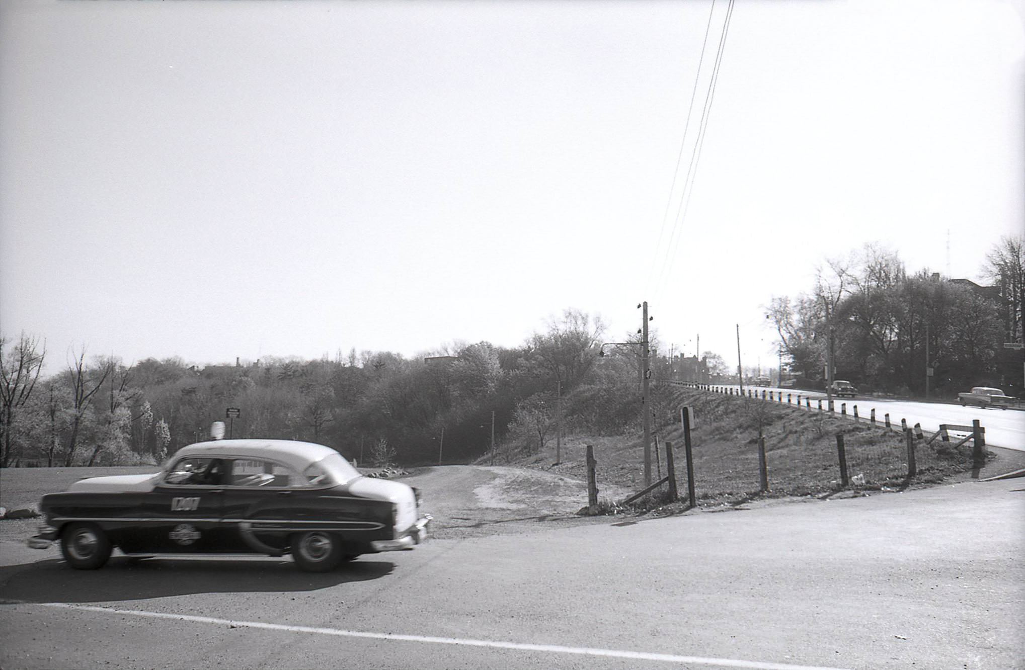 Looking south on Mount Pleasant Road at Roxborough Drive as a taxi drifts by, early 1960s.