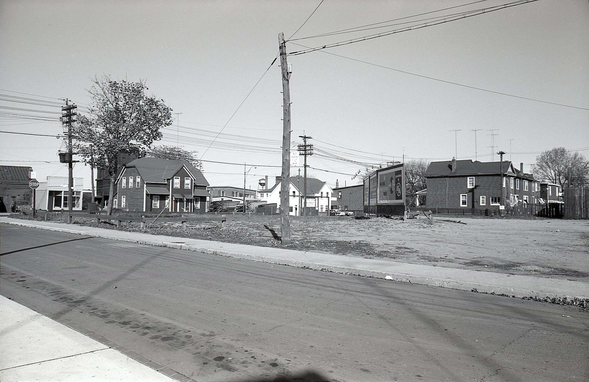 Wayland Avenue, looking northeast toward Gerrard, 1960. The empty lot with billboards is now occupied by Kinsmen Manor.